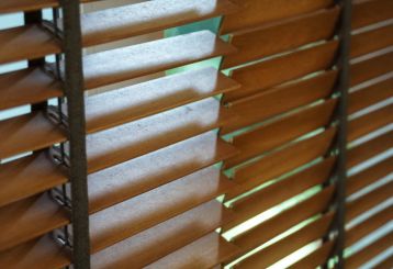 Faux wood horizontal blinds complementing a chic interior.